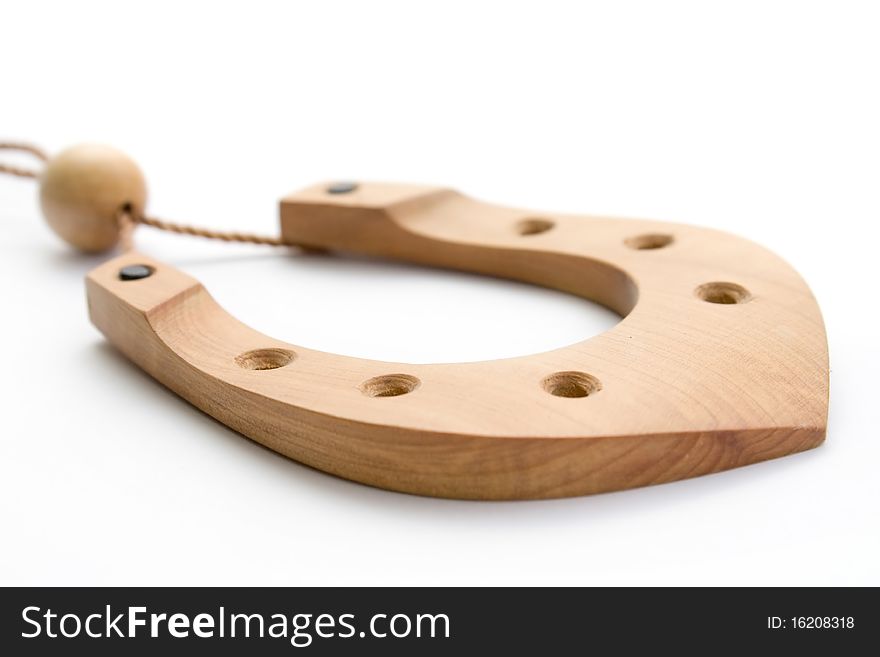 Wooden horseshoe souvenir on a thread isolated on white background