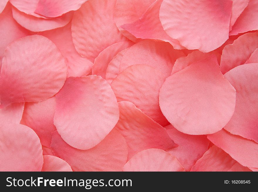Pink artificial rose petals background