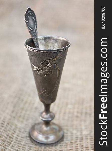 Silver goblet with silver spoon