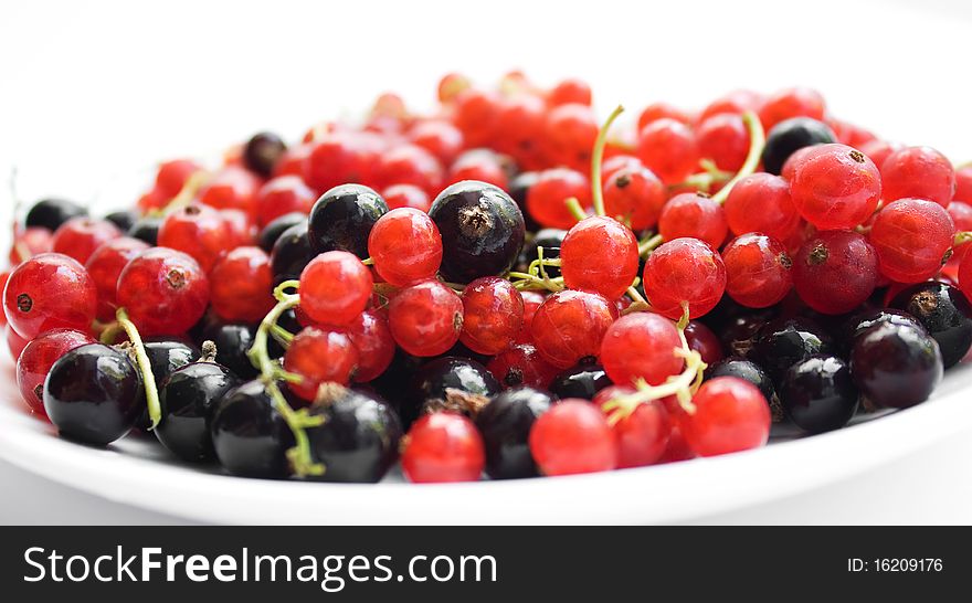 Fresh Red And Black Currant On Plate