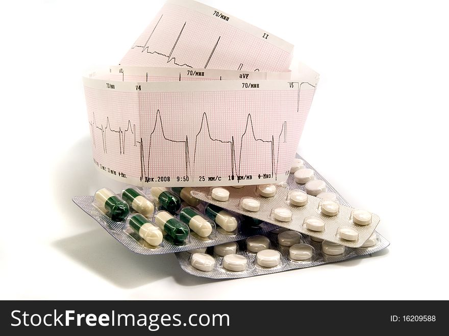 Cardiogram and pills against white background