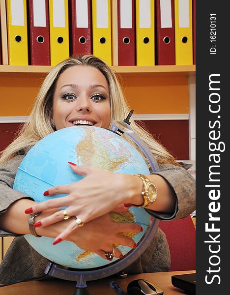 Business woman and globe in the office