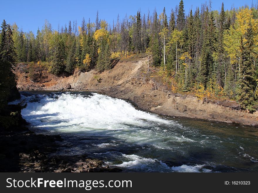 Autumn starts ate Cheslatta Falls, British Columbia, Canada