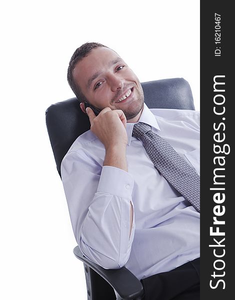 Successful businessman in his chair, talking on mobile phone and smiling, isolated on white. Successful businessman in his chair, talking on mobile phone and smiling, isolated on white