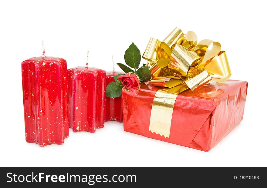 Christmas festive gift with red candles and rose. Isolated over white background. Christmas festive gift with red candles and rose. Isolated over white background.