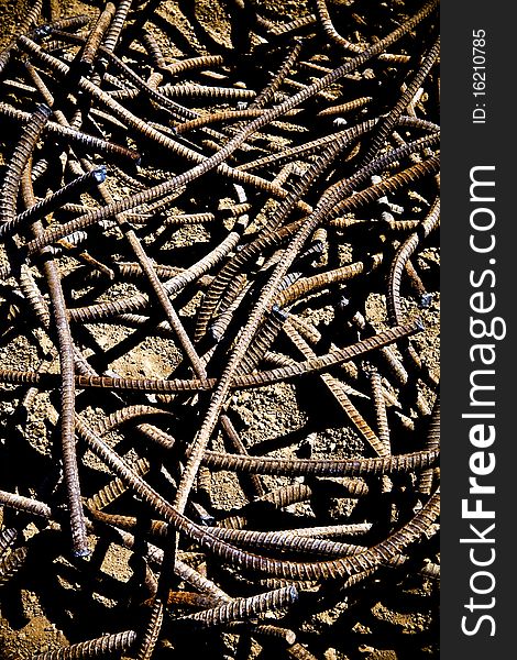 A pile of twisted rebar lays on the ground. A pile of twisted rebar lays on the ground