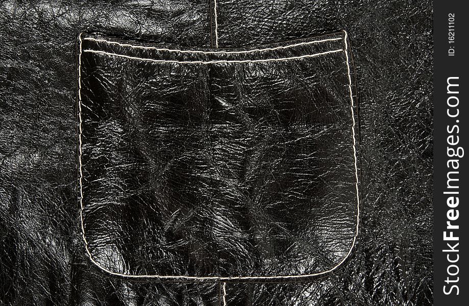 Stitched pocket on shiny black leather clothing showing detailed texture. Stitched pocket on shiny black leather clothing showing detailed texture.