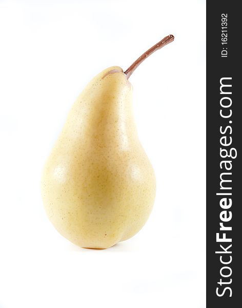 One yellow ripe pear with stem on a white isolated background. One yellow ripe pear with stem on a white isolated background