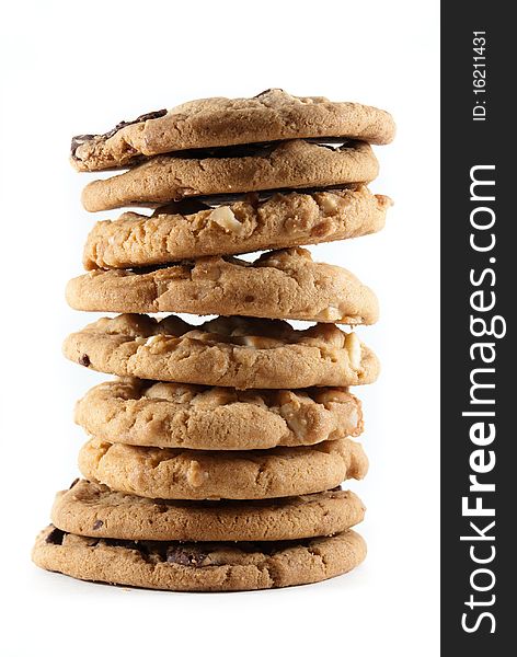 Tall stack of mixed chocolate chip and macadamia nut cookies on a white isolated background. Tall stack of mixed chocolate chip and macadamia nut cookies on a white isolated background.