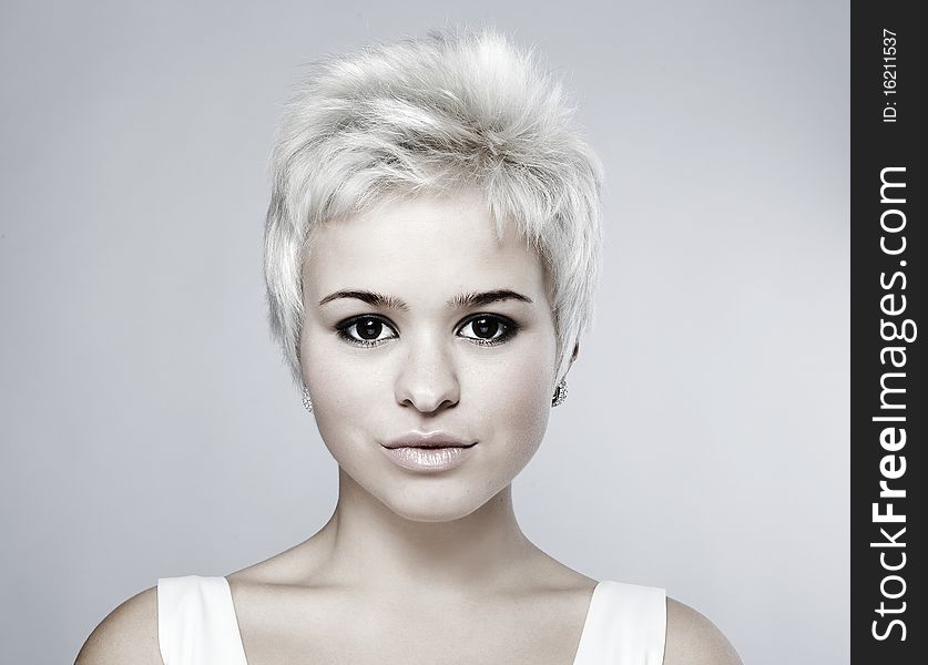 Portrait of an attractive teenage girl on grey background