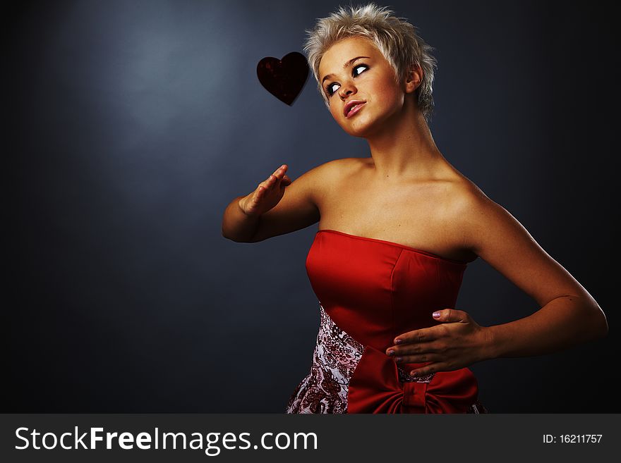 Beautiful model dressed as fashion fairy posing on black background