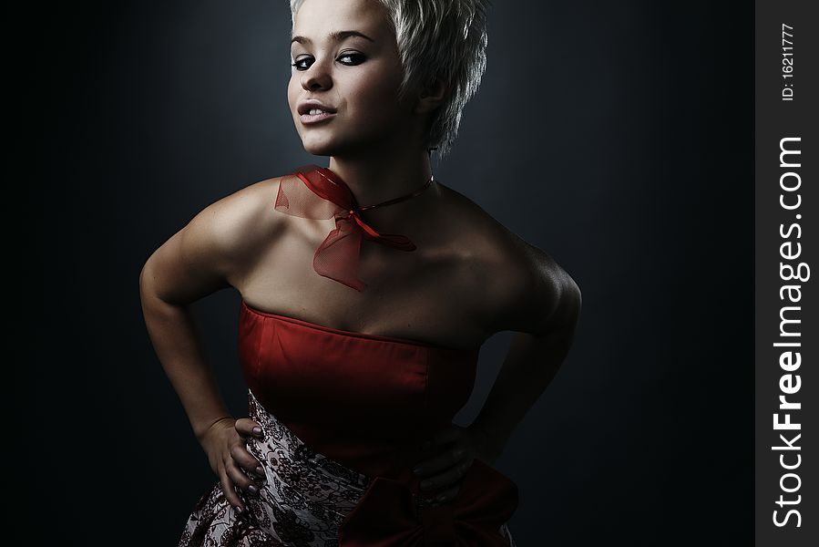 Beautiful model dressed as fashion fairy posing on black background