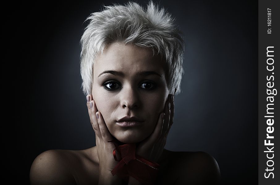 Beautiful model dressed as fashion fairy posing on black background