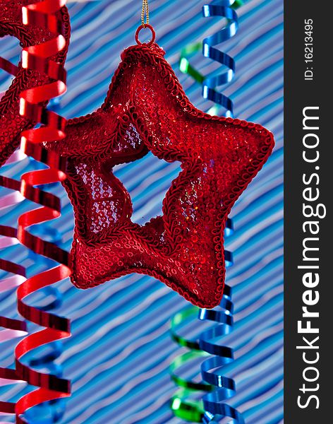 Red christmas star and ribbons on blue stripe background. Red christmas star and ribbons on blue stripe background