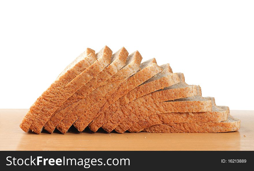 Pile up wheat bread on the wooden table. Pile up wheat bread on the wooden table