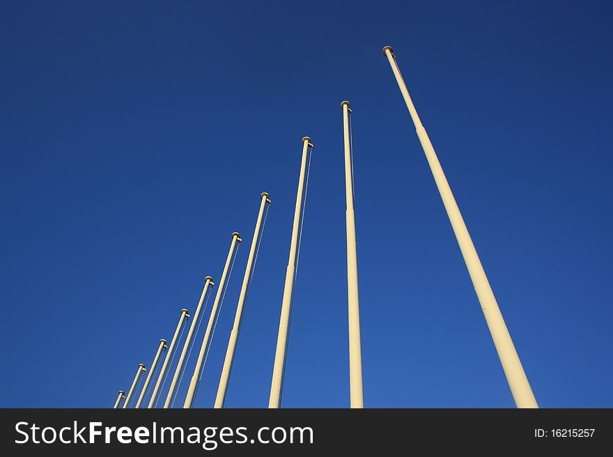 Olympic Flag Poles against a bright blue sky