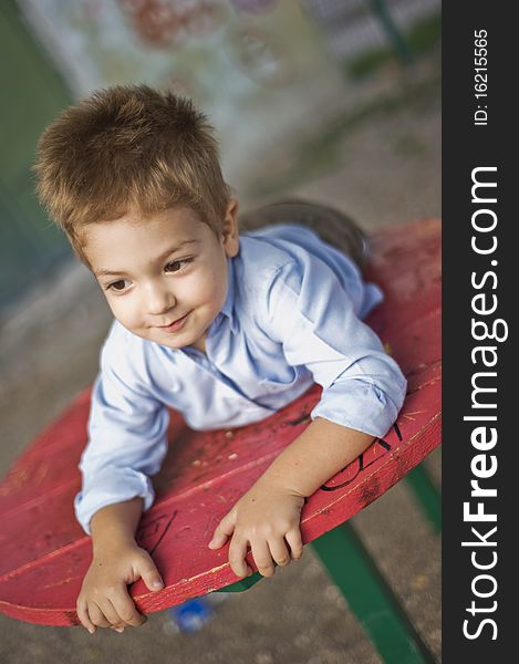 Boy playing in the park, laying on a table