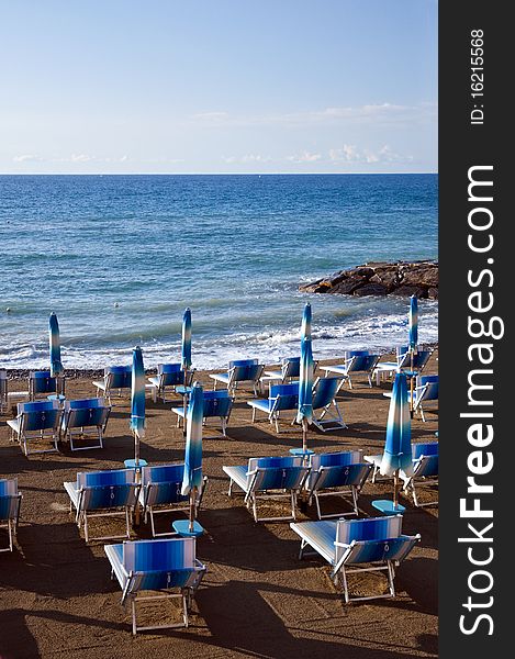 Deck chairs and umbrellas on the beach at dawn