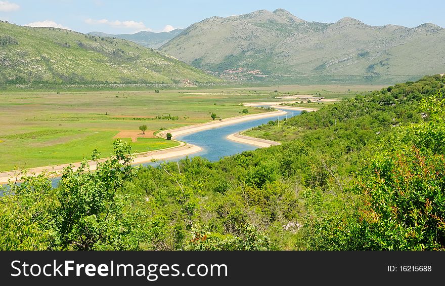 Water channel in bright turquoise color in the mountains of Bosnia Herzegovina on the Balkan. Water channel in bright turquoise color in the mountains of Bosnia Herzegovina on the Balkan