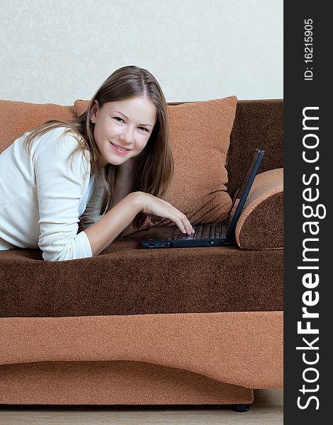 Woman With Laptop On The Sofa