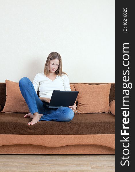 Woman With Laptop On The Sofa