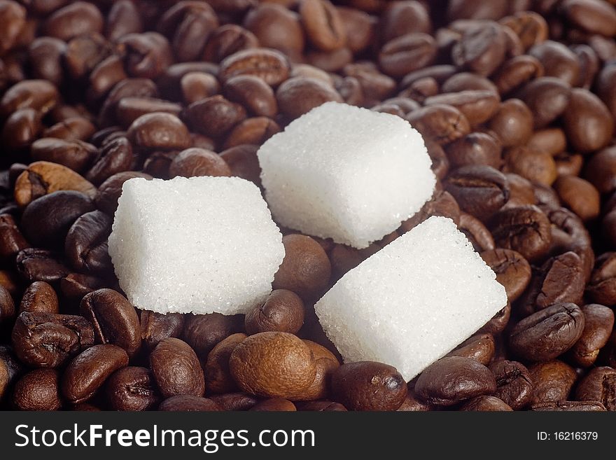 Pieces of sugar lying on the coffee beans. Pieces of sugar lying on the coffee beans