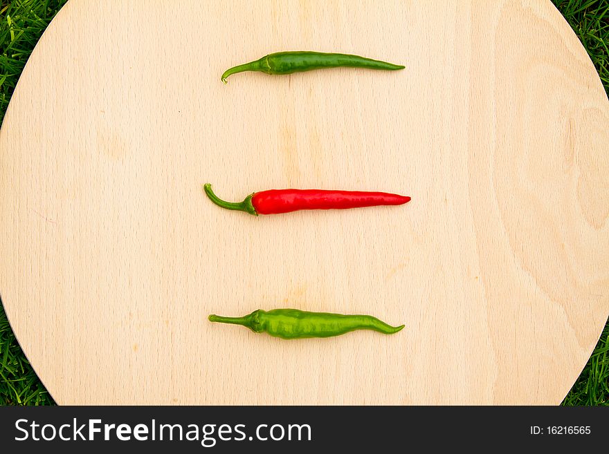 Three chilli hot red and green peppers. Three chilli hot red and green peppers