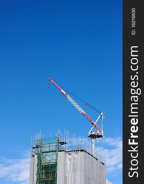 Construction crane on a sky background