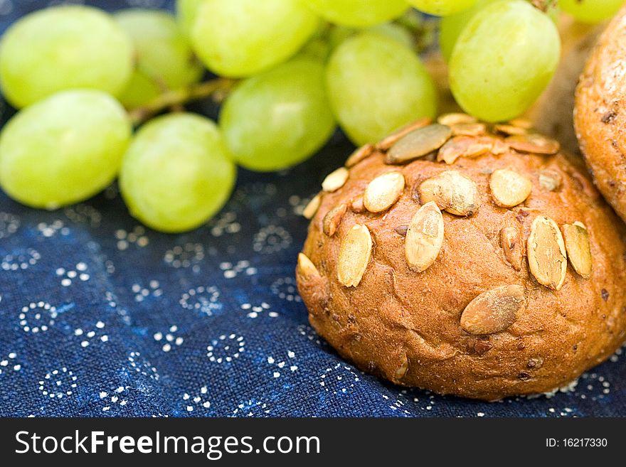 Bread with grapes on blue canvas