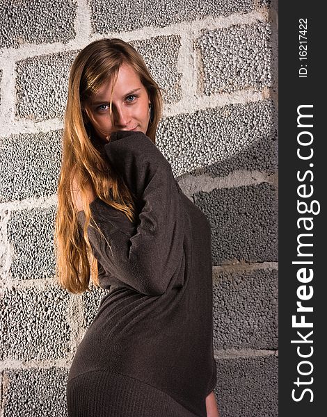 Portrait of a pensive woman near a wall. Portrait of a pensive woman near a wall