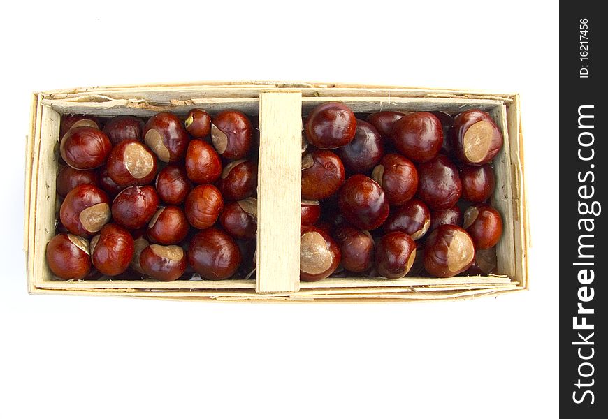 Chestnuts in a basket isolated on white background. Chestnuts in a basket isolated on white background