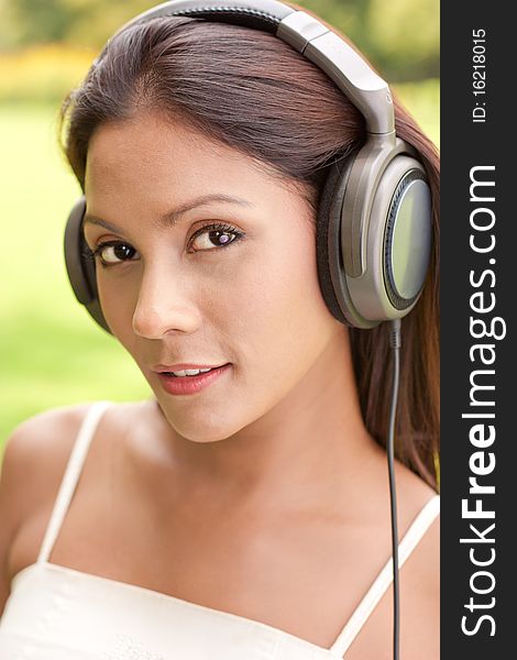 Attractive mixed race girl listening to music. Attractive mixed race girl listening to music