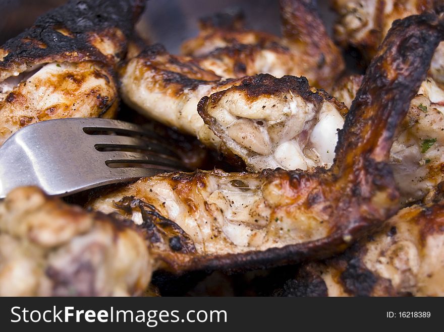 Ready to be eaten, grilled chicken on the plate.