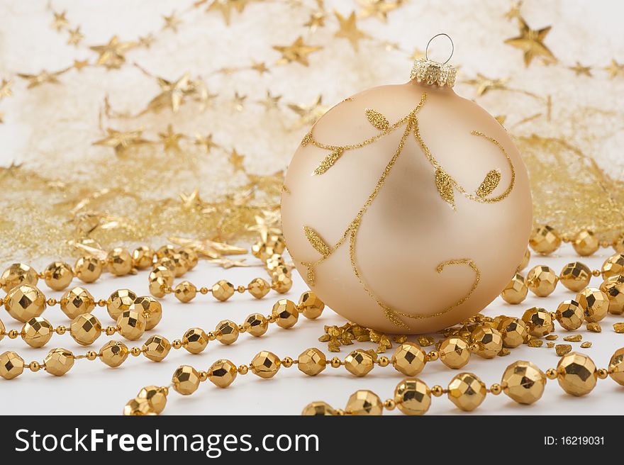 Golden christmas decoration with ball and pearl necklace