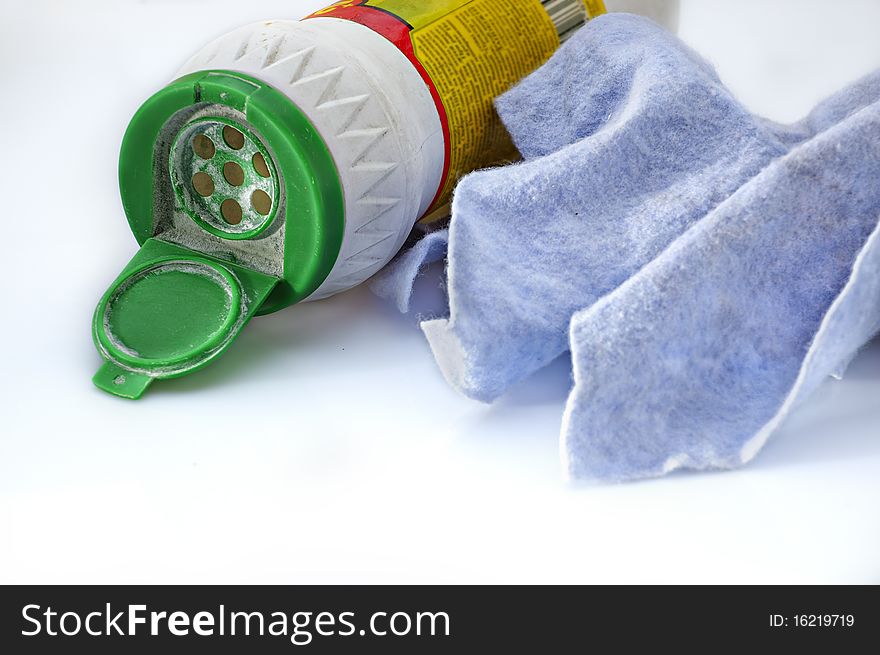 Washing-up liquid and napkin on a light background. Washing-up liquid and napkin on a light background