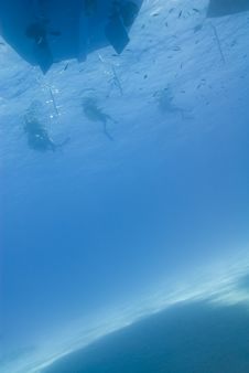 Underwater View Of Three Scuba Diver Silhouettes. Stock Photo Underwater View Of Three Scuba Diver Silhouettes. Stock Photo