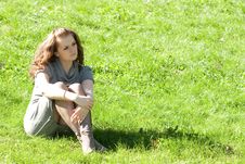 Girl Sitting On Green Grass Royalty Free Stock Photography