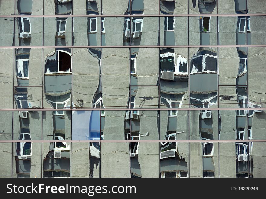 Mirorred wall of city scyscraper abstract background. Distorted reflection of next building. Mirorred wall of city scyscraper abstract background. Distorted reflection of next building