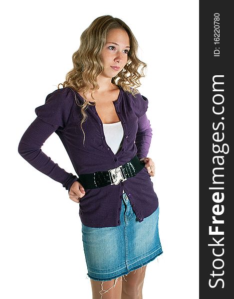 The young beautiful girl in a lilac shirt and jeans skirt. Isolation on a white background