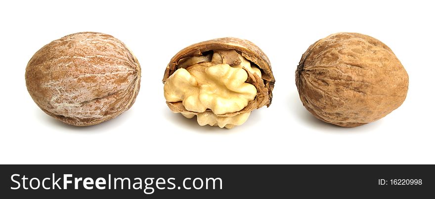 Three fresh walnuts in a row on the white background. One of them is crashed. Three fresh walnuts in a row on the white background. One of them is crashed