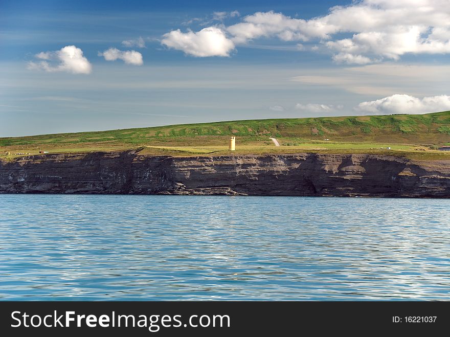 Usavik lighthouse in Iceland with clouds. Usavik lighthouse in Iceland with clouds