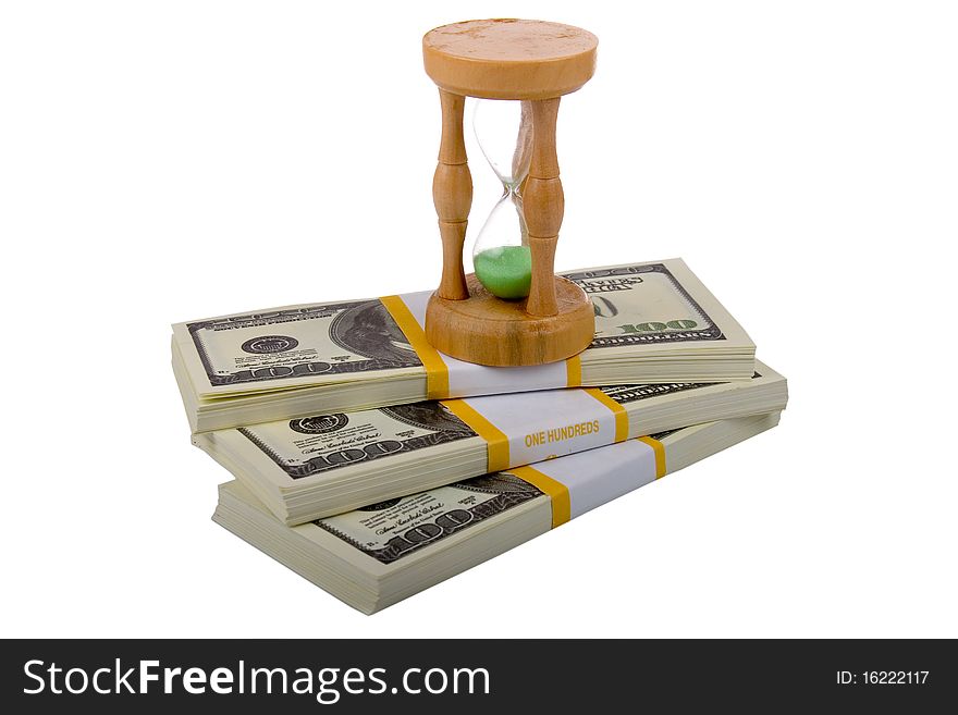 Hourglass on a packs of dollars  isolated on a white background
