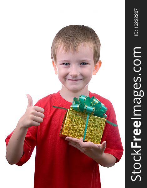 Happy boy with a gift shows the sign of OK, isolated on a white background. Happy boy with a gift shows the sign of OK, isolated on a white background