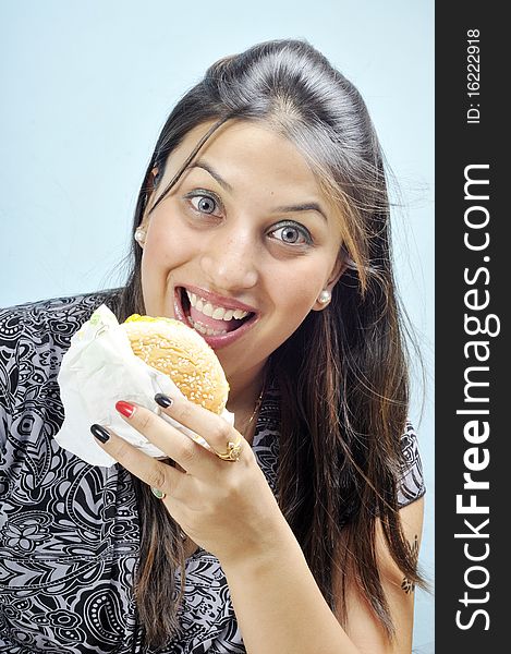 Model making faces while holding veg burger. Model making faces while holding veg burger.