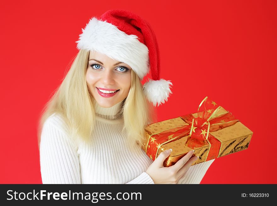 Santa girl holding gifts on a red background