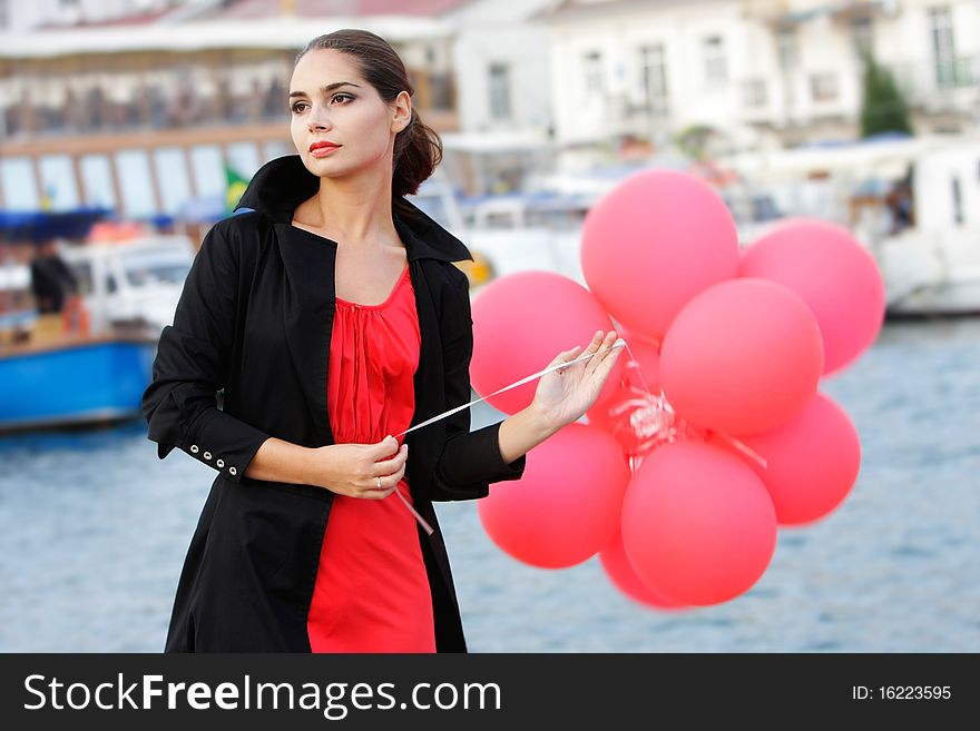 Young Beautiful Woman With Red Balloons