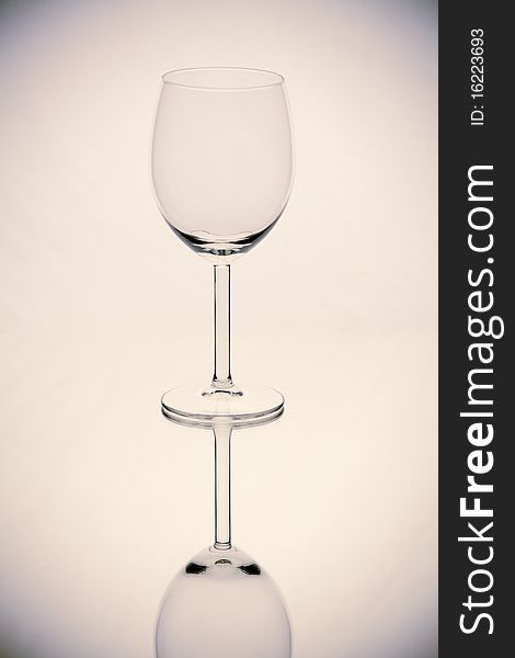 Wine glass on light background with reflection