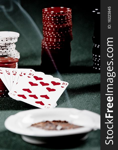 Casino gambling chips and playing cards on green table. Casino gambling chips and playing cards on green table