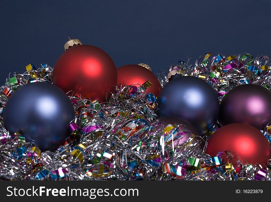 Holiday tree ornaments on tinsel garland