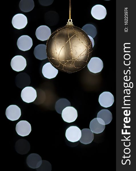 Golden Christmas decoration ball. Blurry lights on background. Golden Christmas decoration ball. Blurry lights on background.